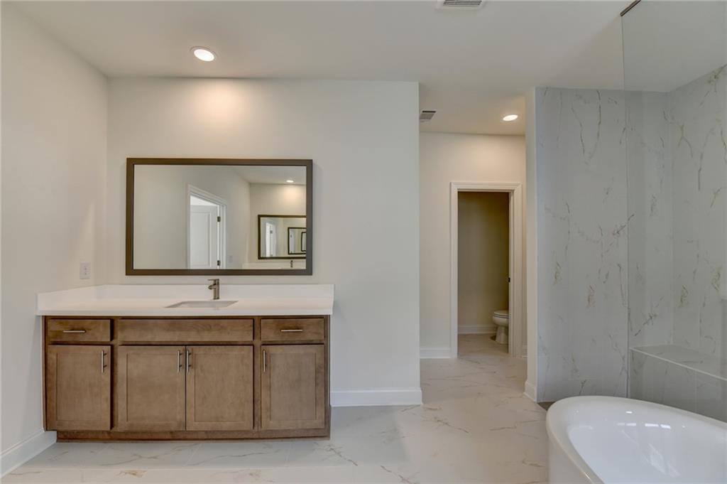 2470 Stewart Road Cumming, GA 30041 - Photo 47 of 61 a bathroom with a sink and a mirror