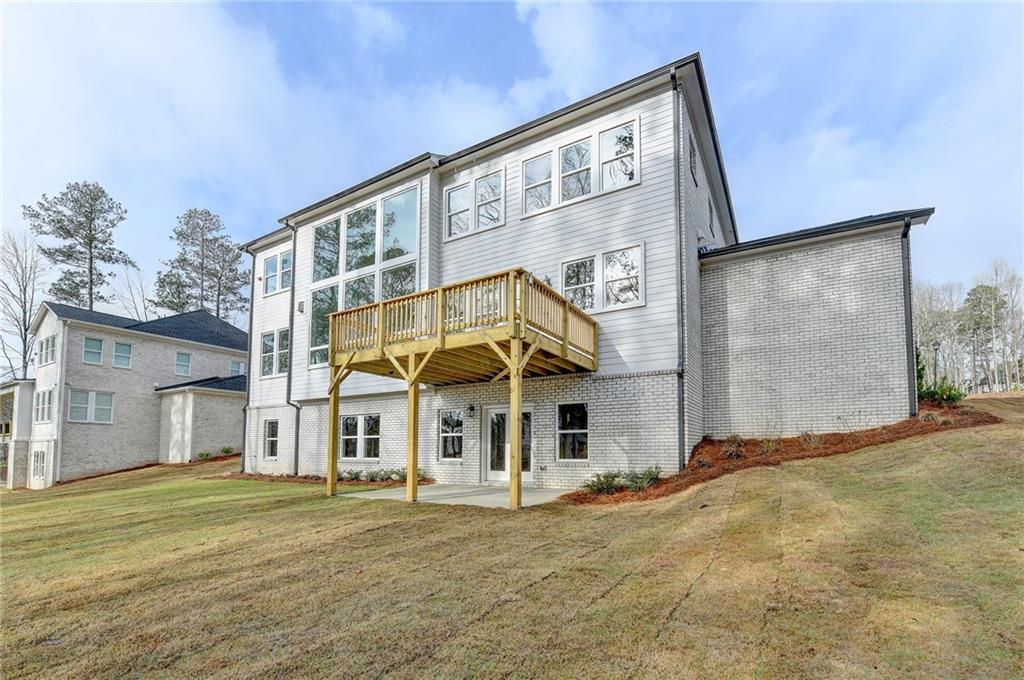 2470 Stewart Road Cumming, GA 30041 - Photo 56 of 61 a view of a white house with a big yard and large trees