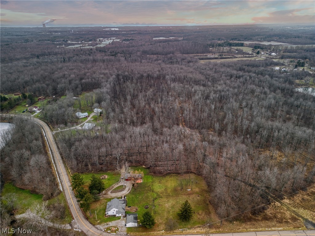 15594 Moseley Road Madison, OH 44057 - Photo 3 of 7 Aerial view at dusk of a wooded view