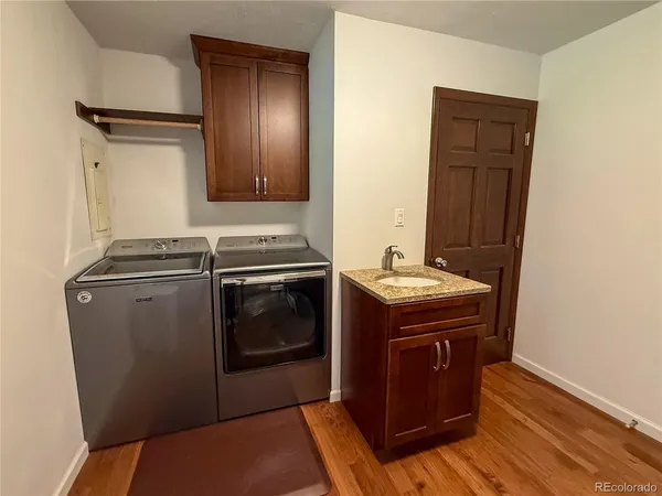 a kitchen with a stove sink and cabinets