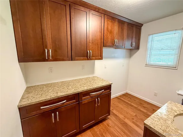 a view of a kitchen with wooden floor