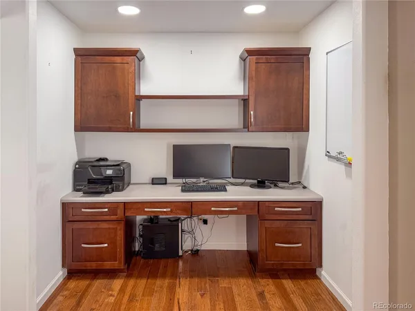 a room with a sink and wooden floor