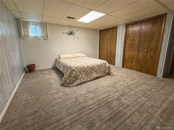 a spacious bedroom with a bed and a shower