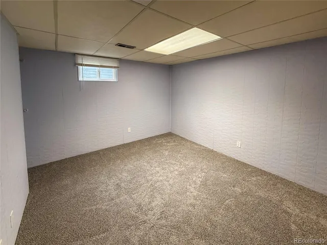 a bathroom with a granite countertop double vanity sink and mirror