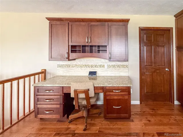 a view of kitchen with cabinets and wooden floor