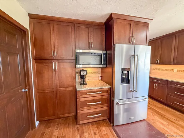 a kitchen with cabinets and stainless steel appliances