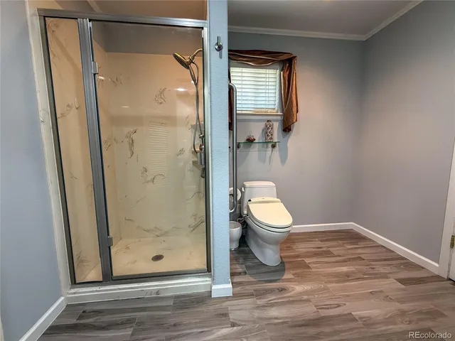 a bathroom that has a toilet shower and a sink