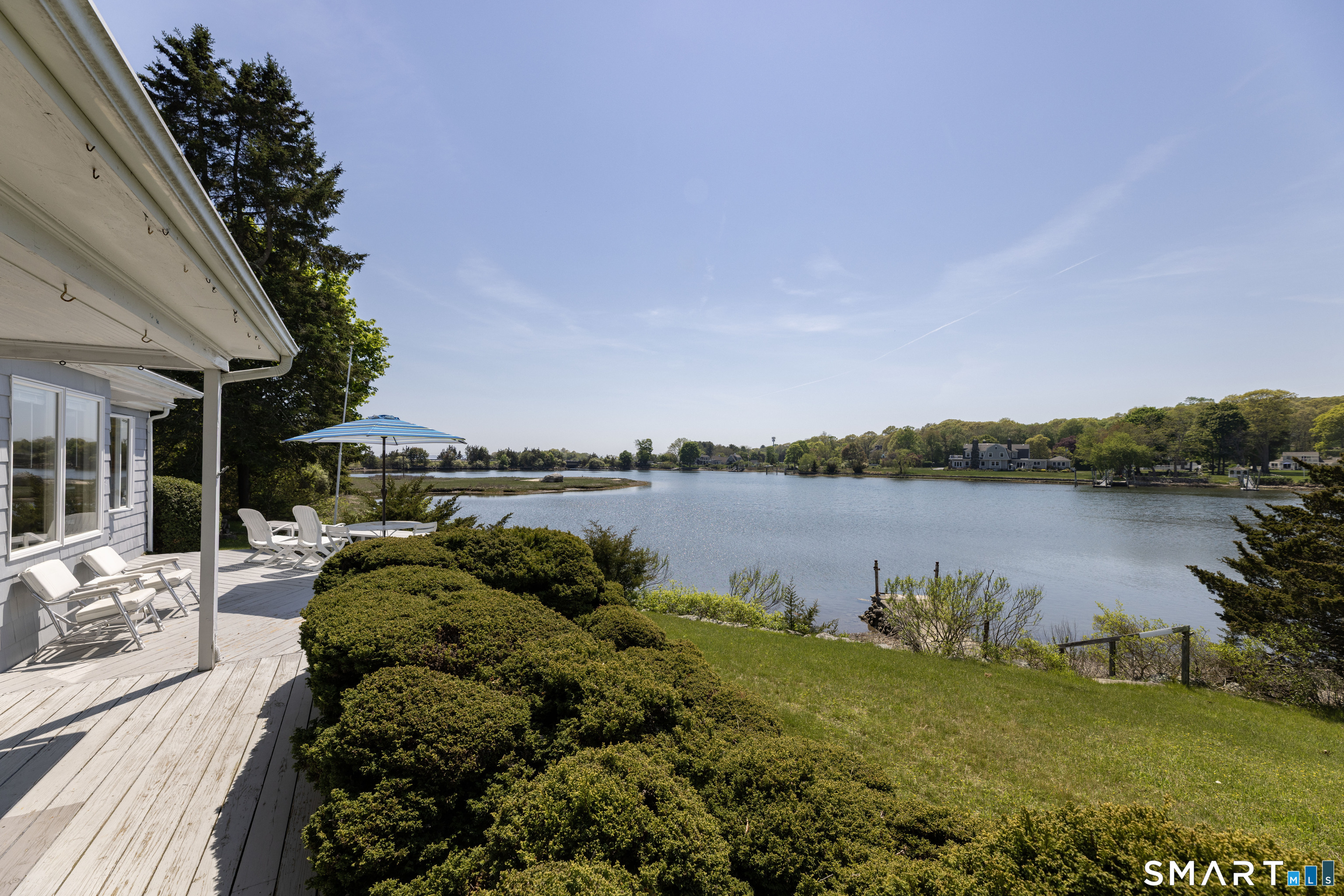 27 Wilbur Road Stonington, CT 06378 - Photo 22 of 40 a backyard of a house with lots of green space and lake view