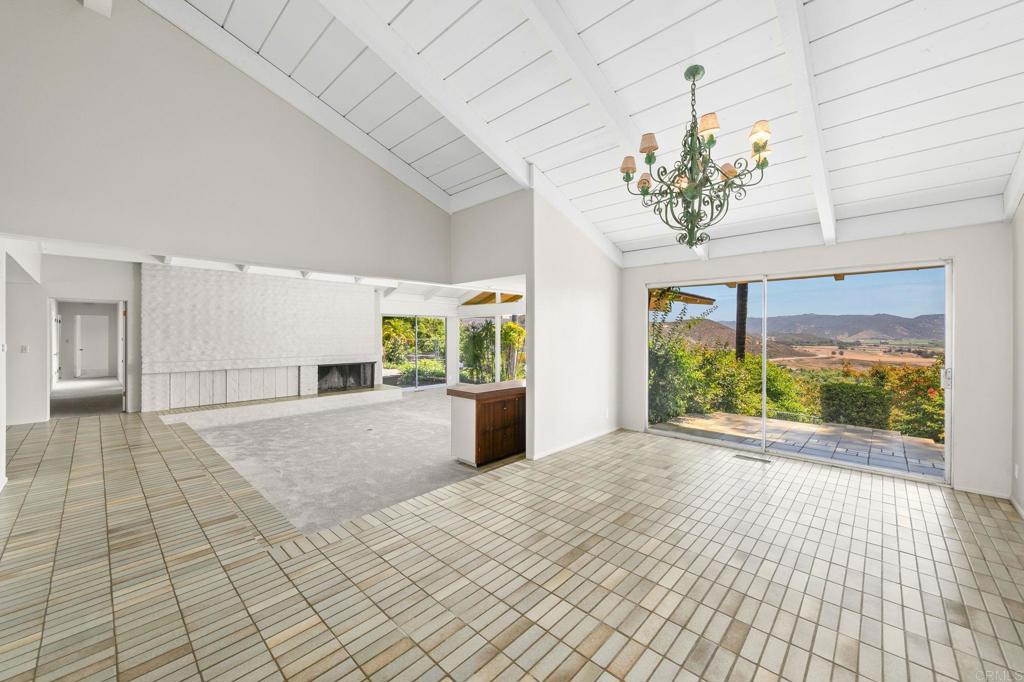 14048 San Pasqual Valley Road Escondido, CA 92027 - Photo 11 of 55 a view of a room with a chandelier and large windows