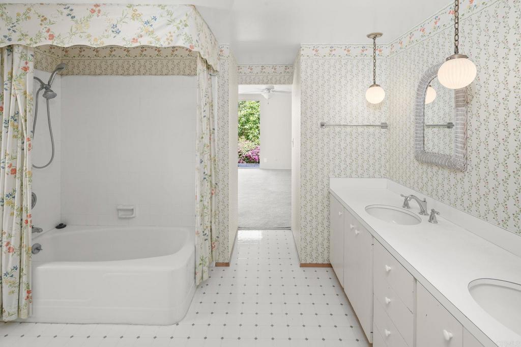 14048 San Pasqual Valley Road Escondido, CA 92027 - Photo 29 of 55 a bathroom with a tub sink and mirror
