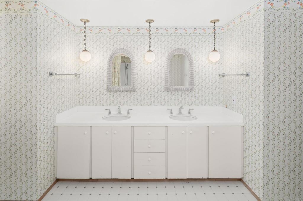 14048 San Pasqual Valley Road Escondido, CA 92027 - Photo 30 of 55 a spacious bathroom with a double vanity sink and a mirror