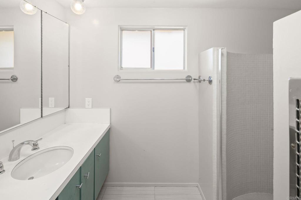 14048 San Pasqual Valley Road Escondido, CA 92027 - Photo 37 of 55 a bathroom with a sink and a mirror