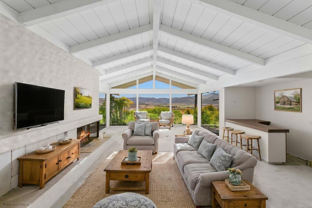 14048 San Pasqual Valley Road Escondido, CA 92027 - Photo 6 of 55 a living room with furniture and a flat screen tv