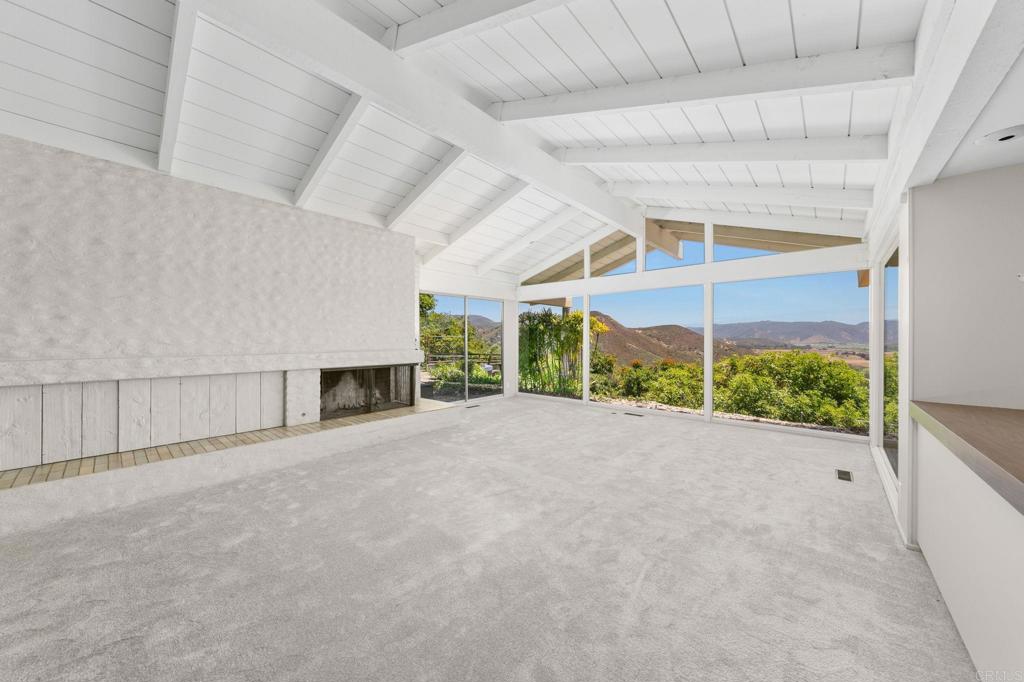 14048 San Pasqual Valley Road Escondido, CA 92027 - Photo 7 of 55 a view of an empty room with a fireplace and a window