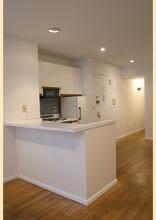 a kitchen with stainless steel appliances a sink a stove a microwave a counter top space and cabinets