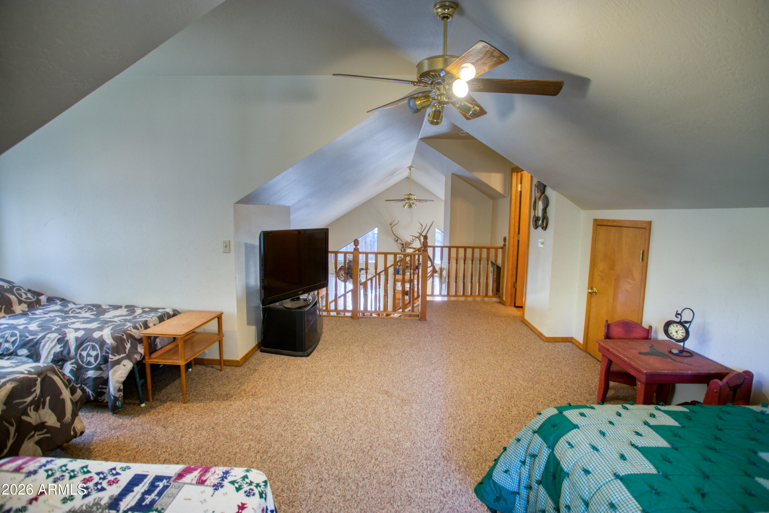 146 Deer Run Road Pinetop, AZ 85935 - Photo 19 of 44 a bedroom with furniture and a chandelier