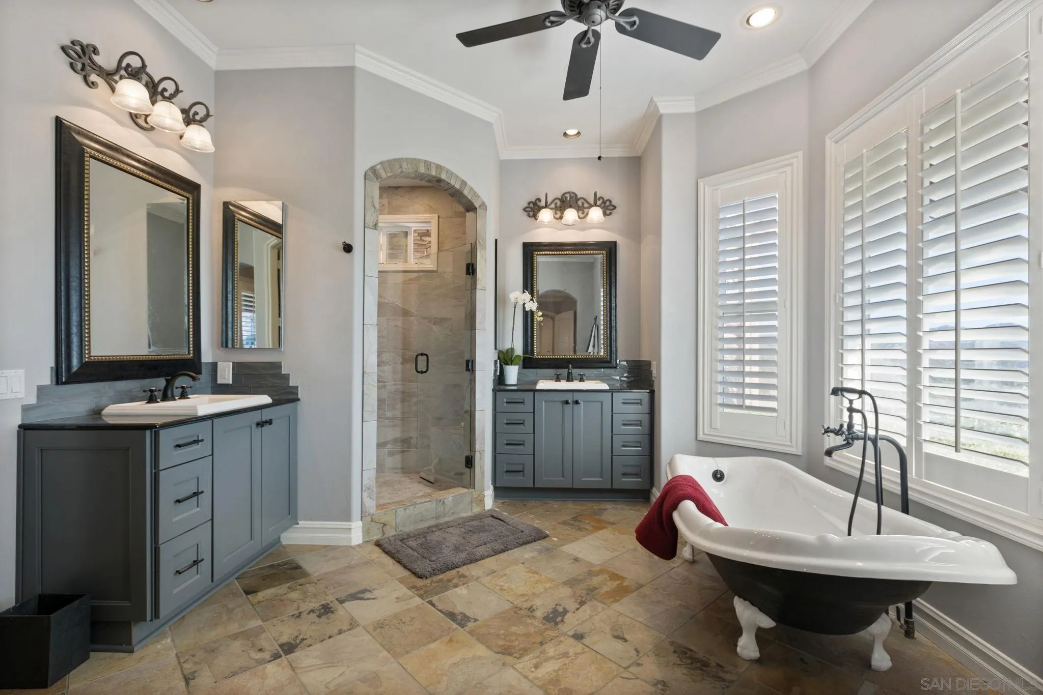 30419 Canyon Estates Road Vista, CA 92084 - Photo 11 of 75 a spacious bathroom with a granite countertop sink a mirror a bathtub and shower