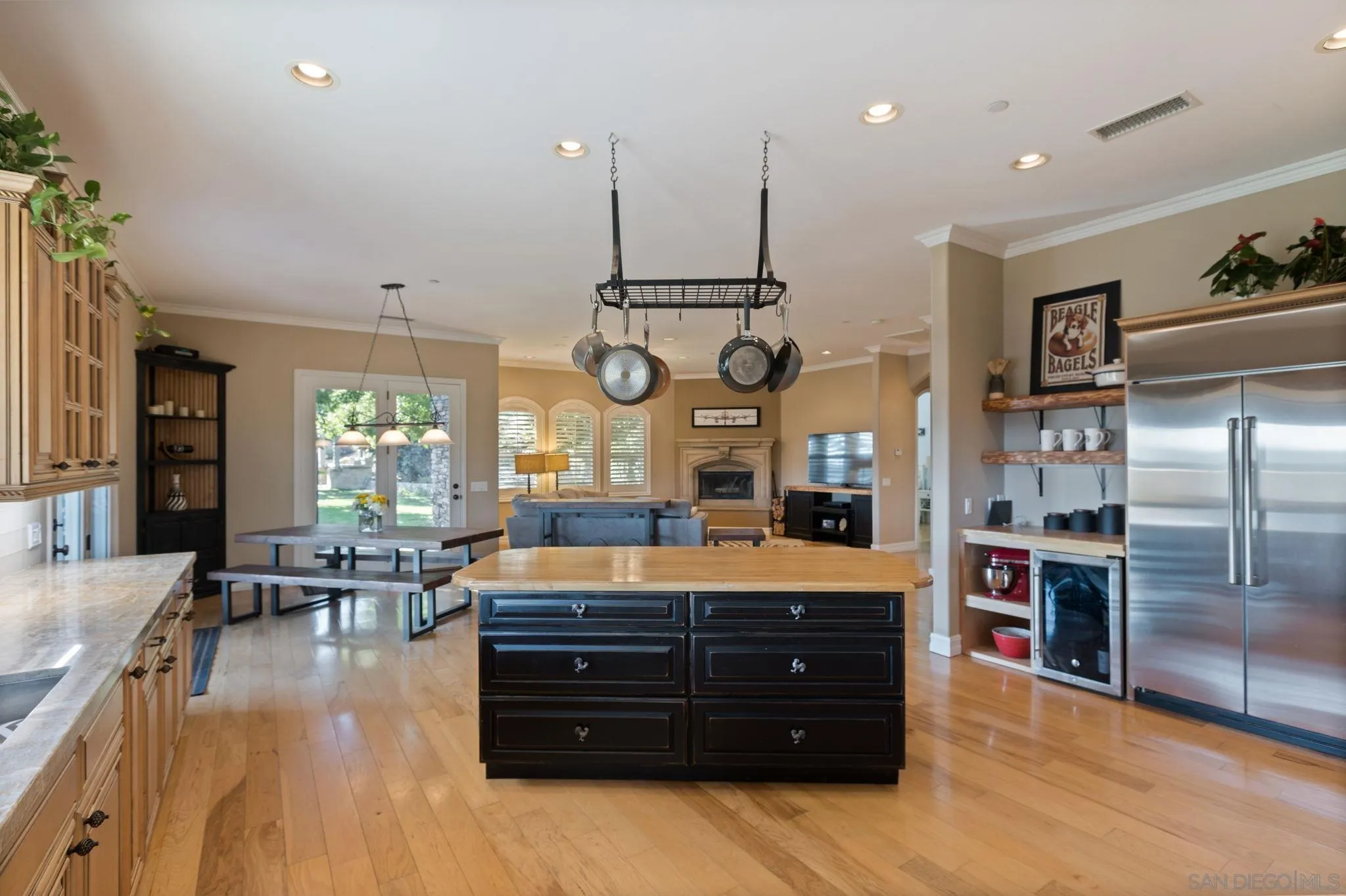 30419 Canyon Estates Road Vista, CA 92084 - Photo 23 of 75 a large kitchen with stainless steel appliances a stove center island with wooden floor and cabinets