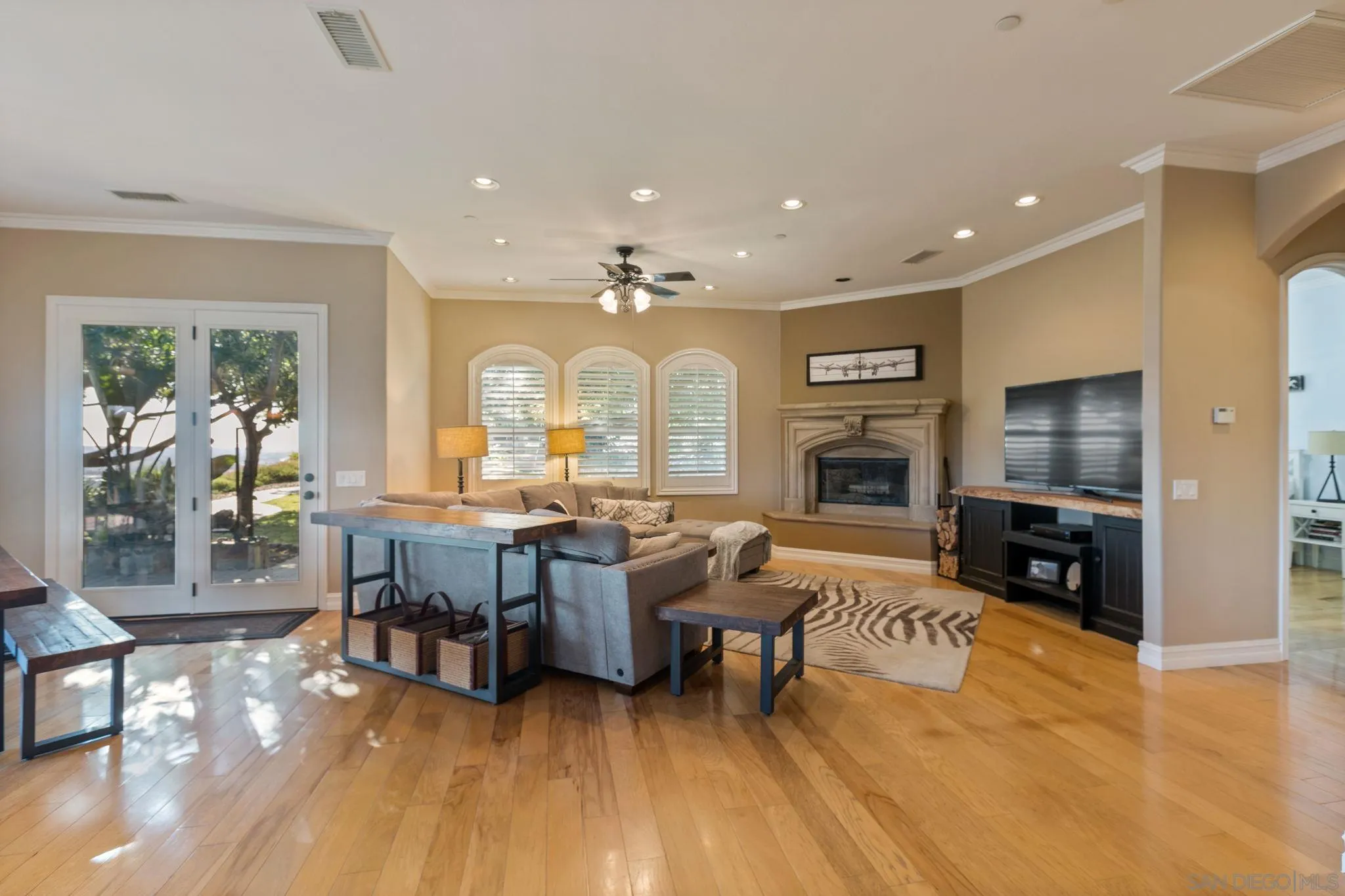 30419 Canyon Estates Road Vista, CA 92084 - Photo 26 of 75 a living room with furniture a fireplace a flat screen tv and wooden floor