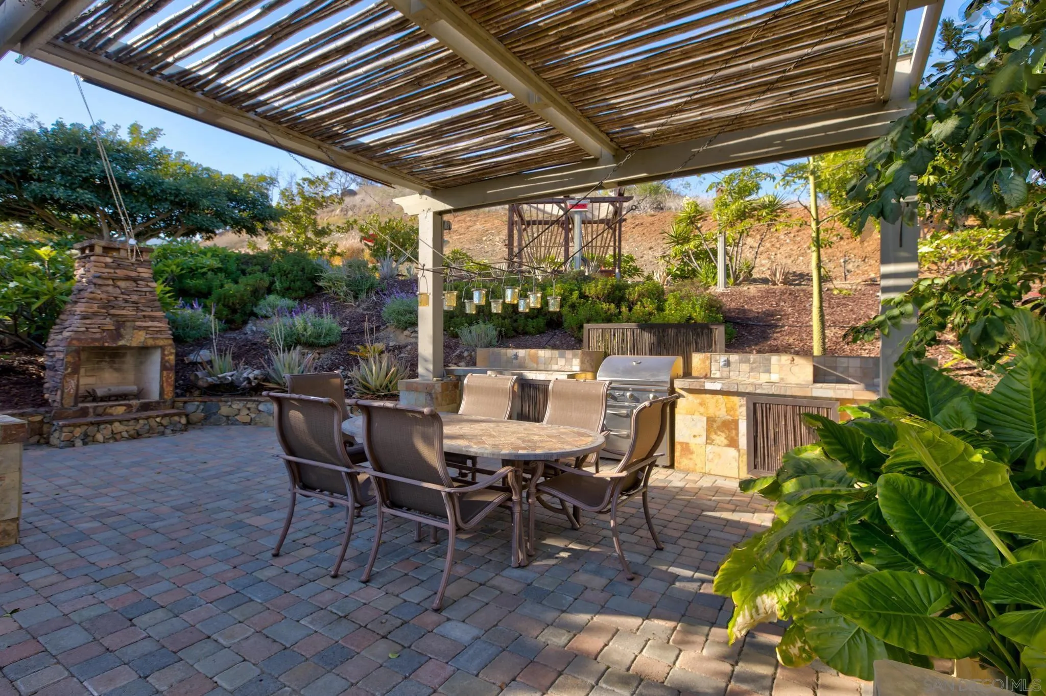 30419 Canyon Estates Road Vista, CA 92084 - Photo 43 of 75 a view of a patio with table and chairs and potted plants