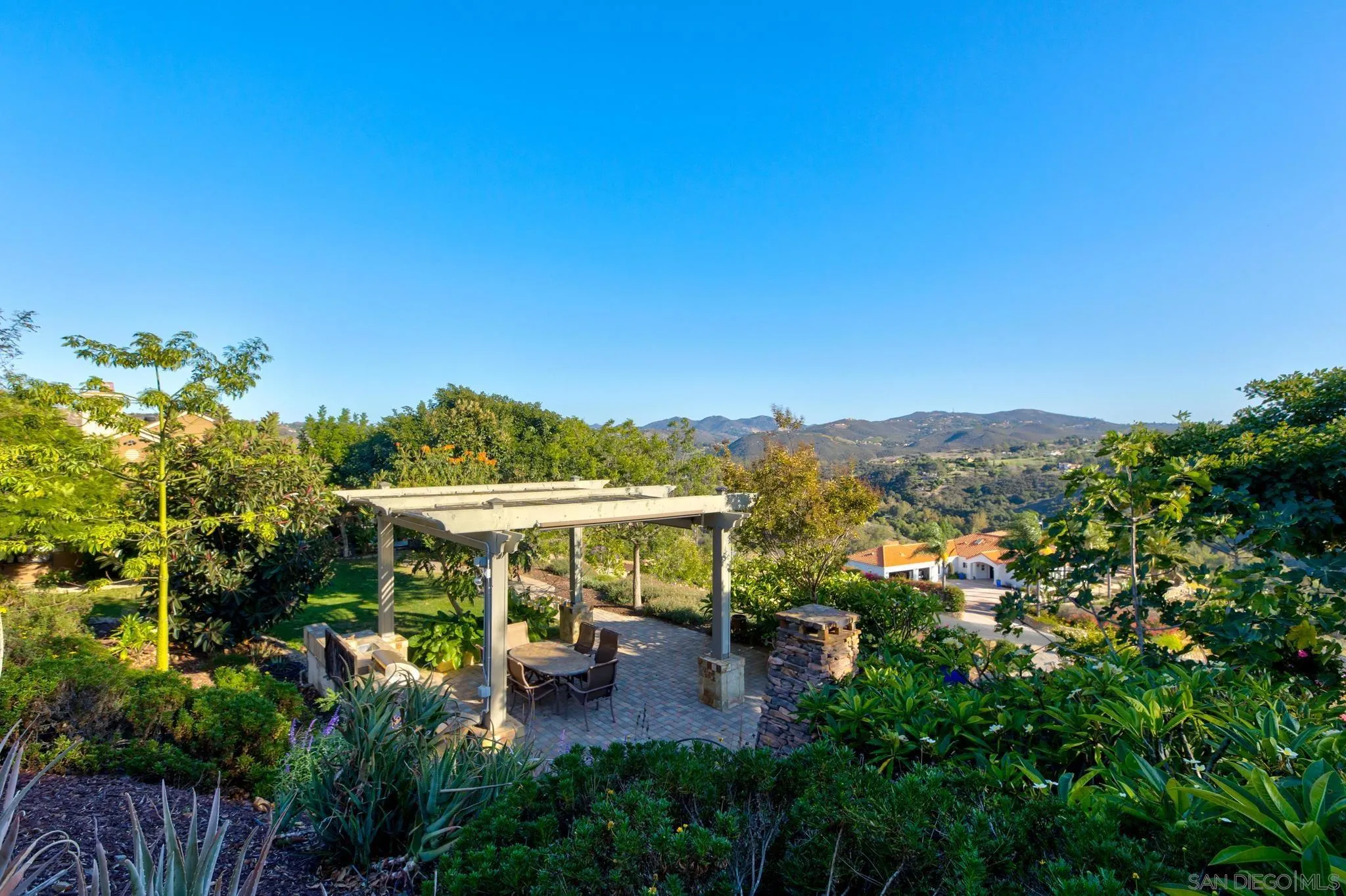 30419 Canyon Estates Road Vista, CA 92084 - Photo 46 of 75 a view of a chairs and table in patio with a wooden fence