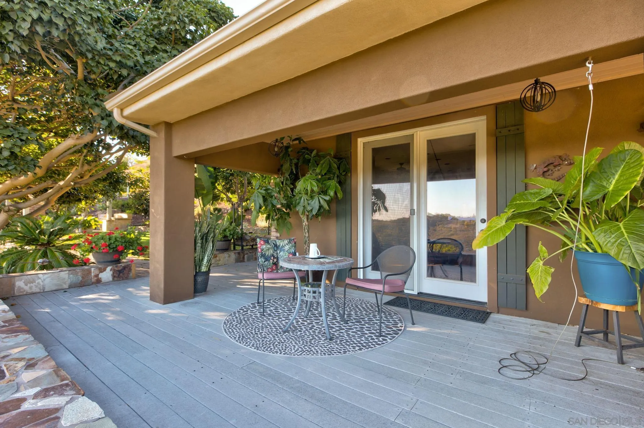 30419 Canyon Estates Road Vista, CA 92084 - Photo 56 of 75 a view of a patio with table and chairs potted plants with wooden floor and fence