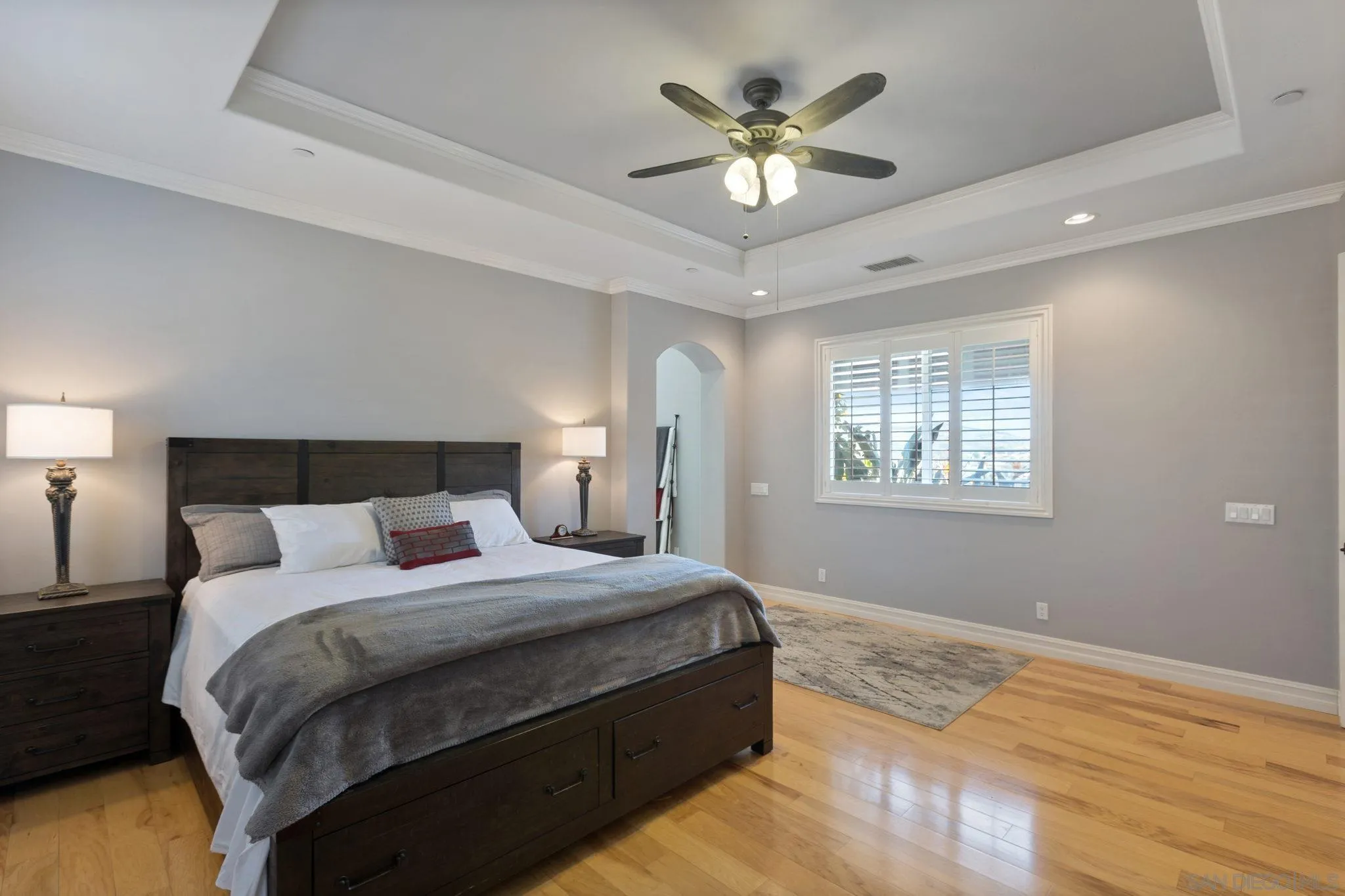 30419 Canyon Estates Road Vista, CA 92084 - Photo 9 of 75 a bedroom with a large bed and a chandelier