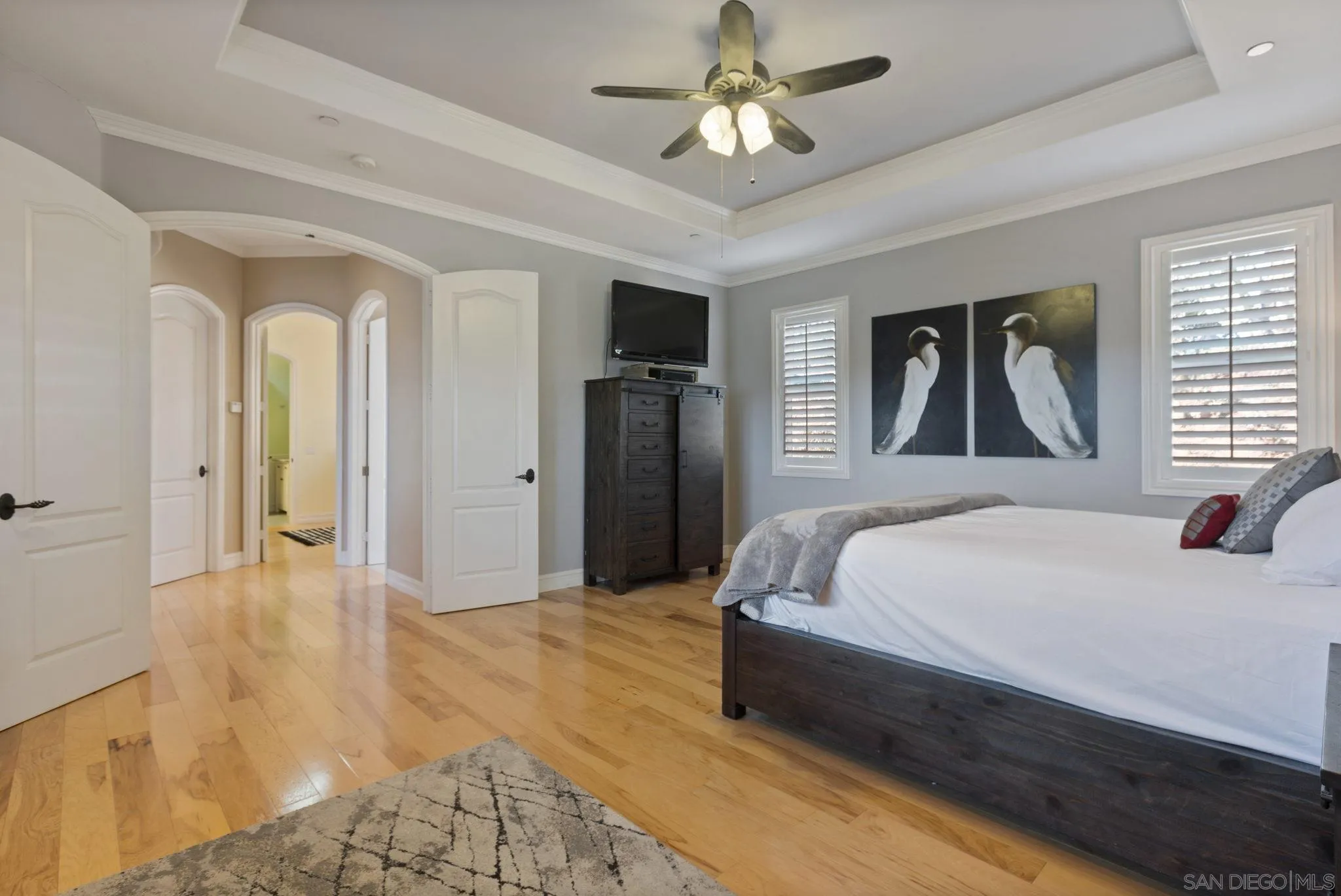 30419 Canyon Estates Road Vista, CA 92084 - Photo 10 of 75 a spacious bedroom with a large bed a chandelier and windows