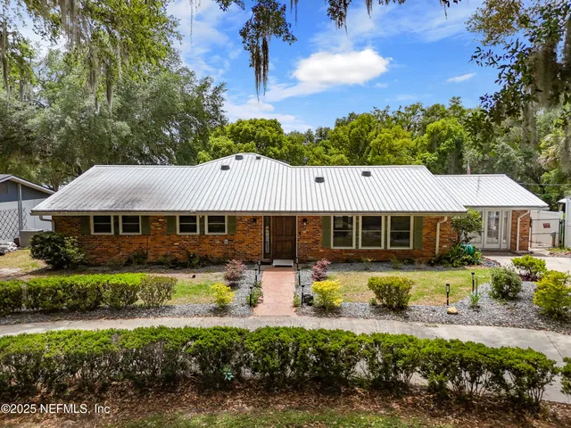 a front view of a house with swimming pool garden and patio