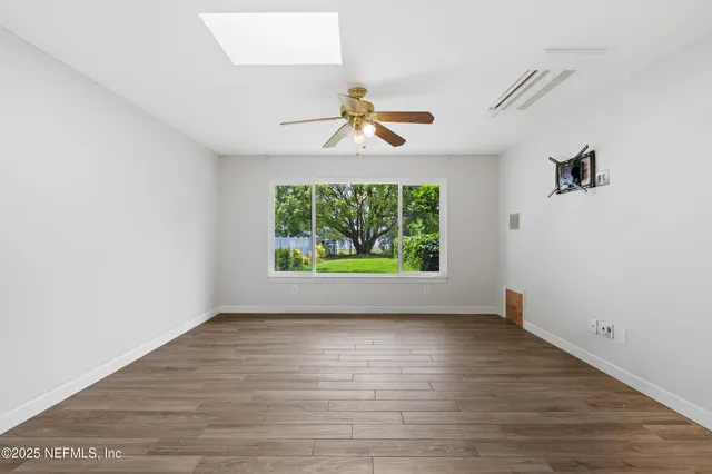 wooden floor in an empty room with a window