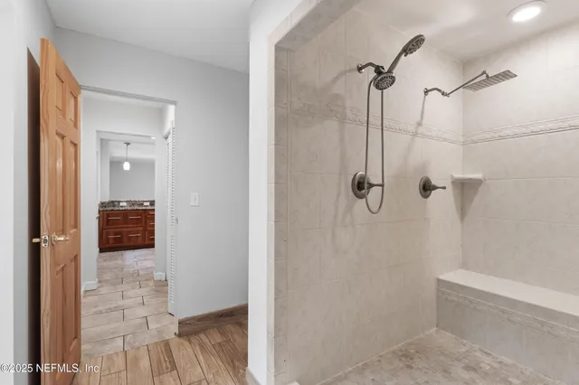 a bathroom with a glass shower door