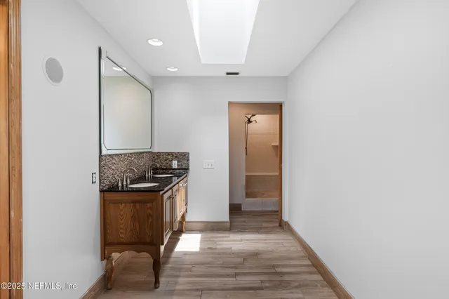 a kitchen with granite countertop a sink and a refrigerator