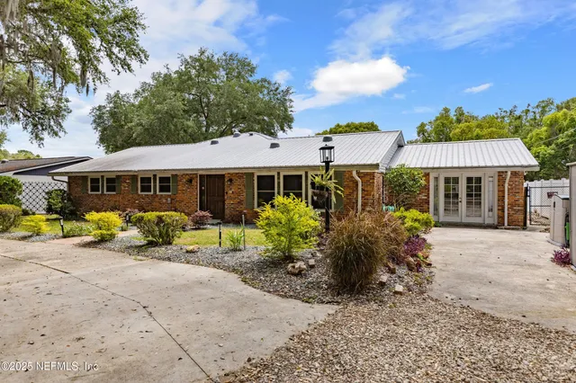 a front view of a house with garden