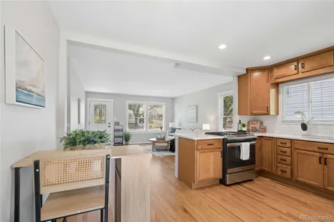a kitchen with stove a sink and cabinets