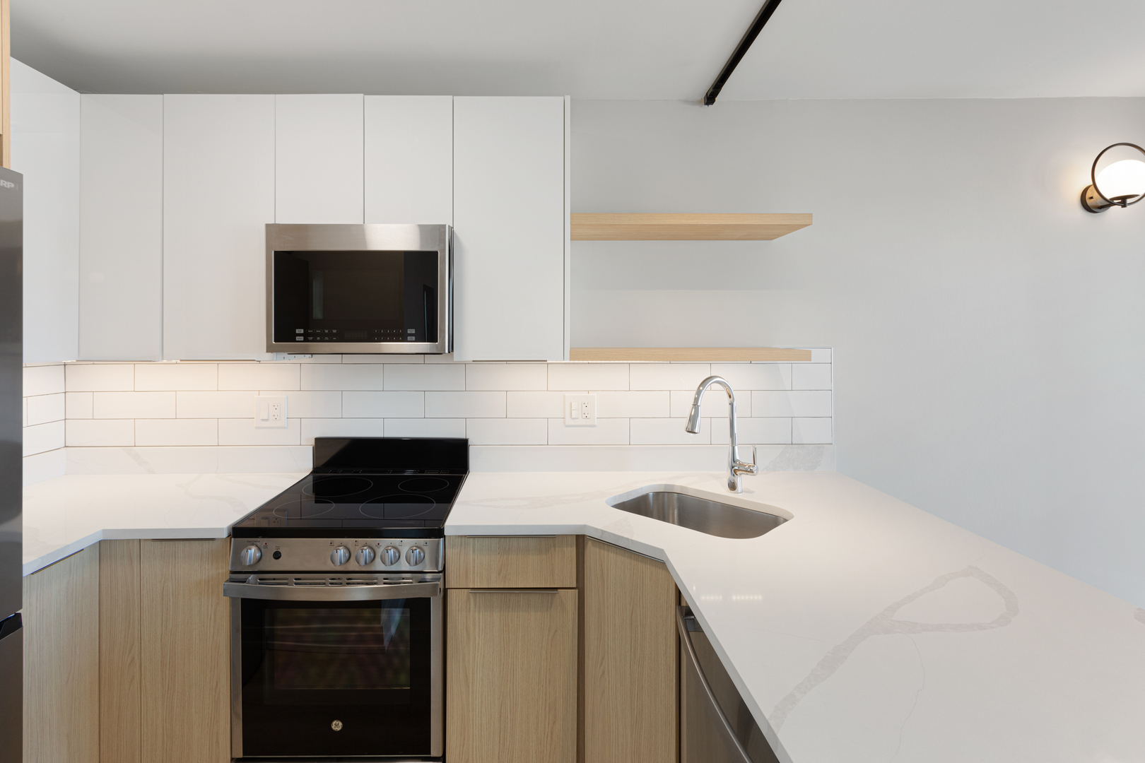 6166 North Sheridan Road, Unit 2L Chicago, IL 60660 - Photo 4 of 15 a kitchen with a sink a stove and microwave