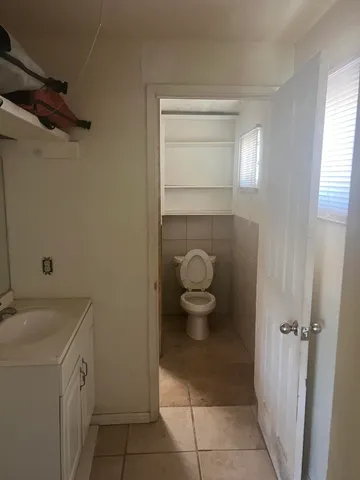 a bathroom with a sink a toilet and a window