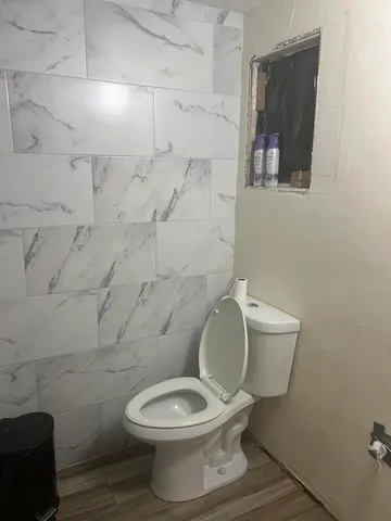 a white toilet sitting next to a bathroom sink