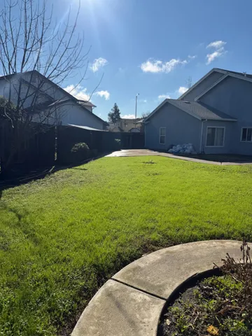 a view of a backyard of the house