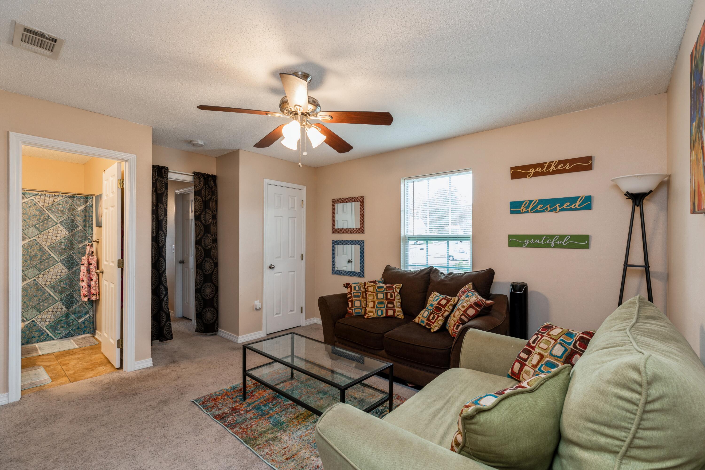 200 Wainwright Drive Crestview, FL 32539 - Photo 14 of 17 a living room with furniture a ceiling fan and a window