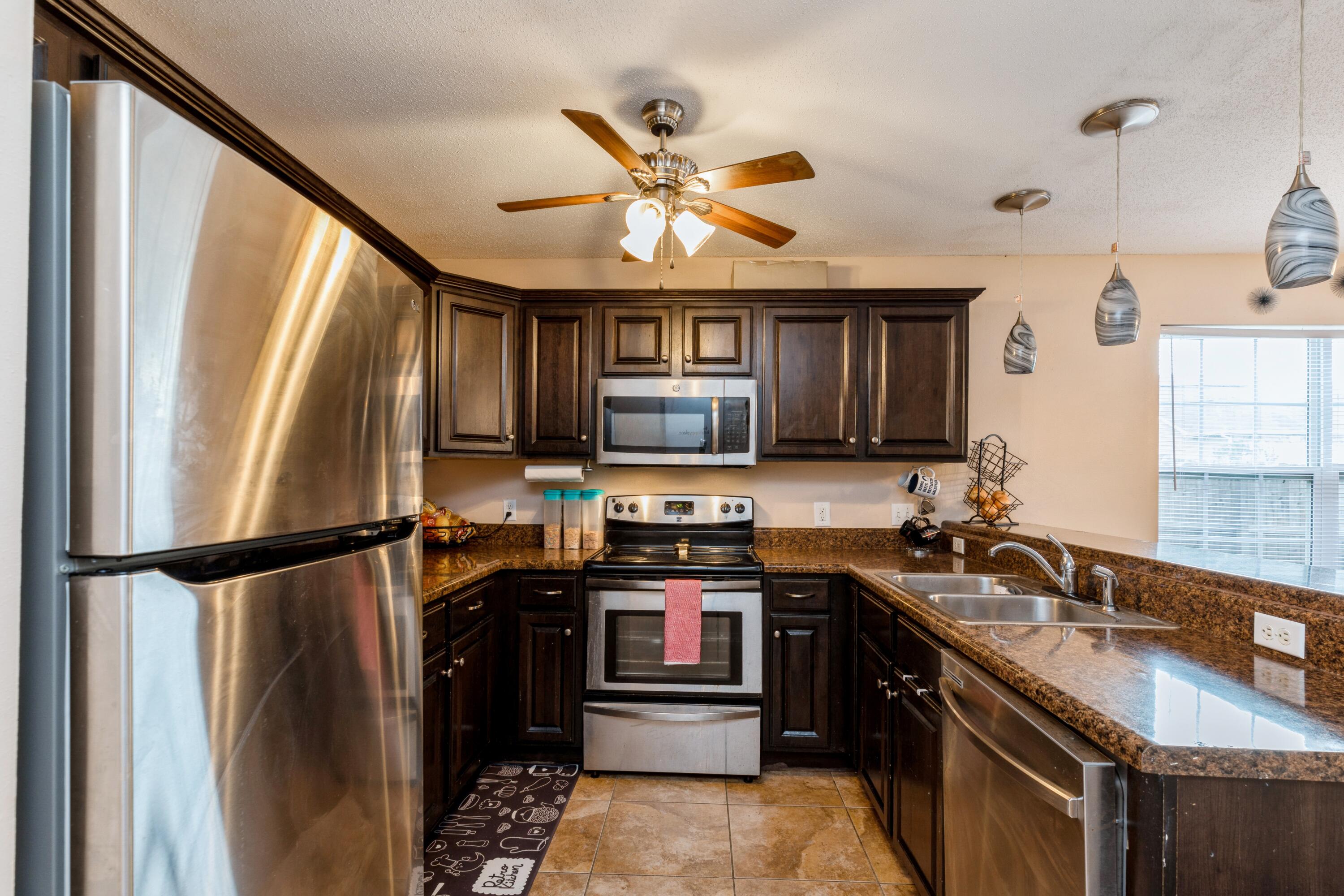 200 Wainwright Drive Crestview, FL 32539 - Photo 4 of 17 a kitchen with stainless steel appliances granite countertop a refrigerator and a sink