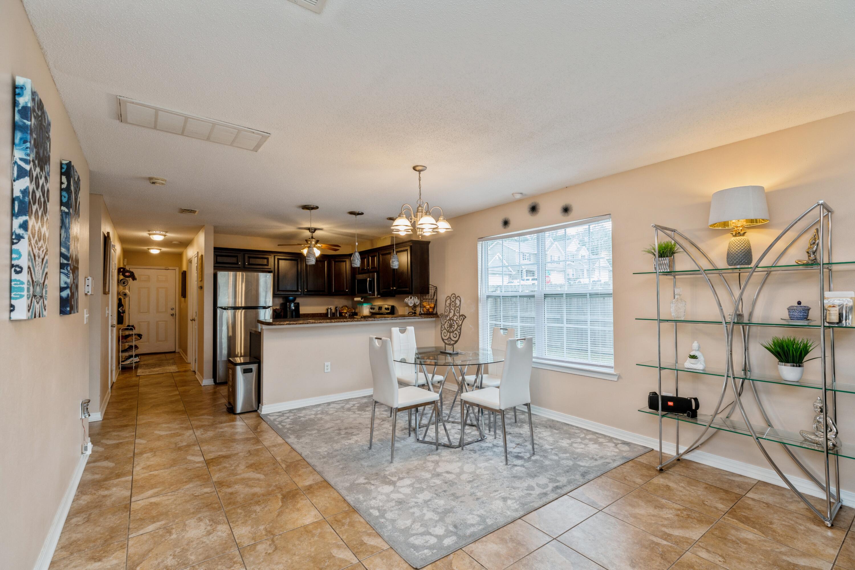 200 Wainwright Drive Crestview, FL 32539 - Photo 8 of 17 a dining room with furniture and a kitchen view