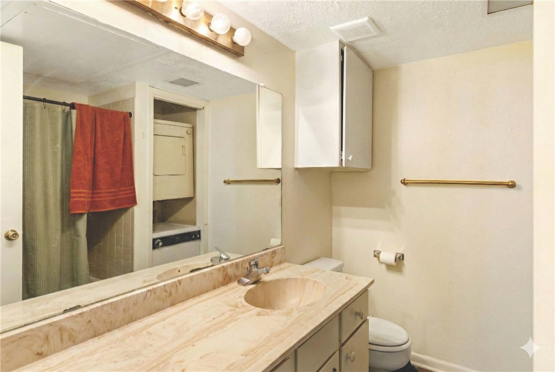 4441 Old College Road, Unit 2104 Bryan, TX 77801 - Photo 13 of 15 a bathroom with a granite countertop sink toilet and shower
