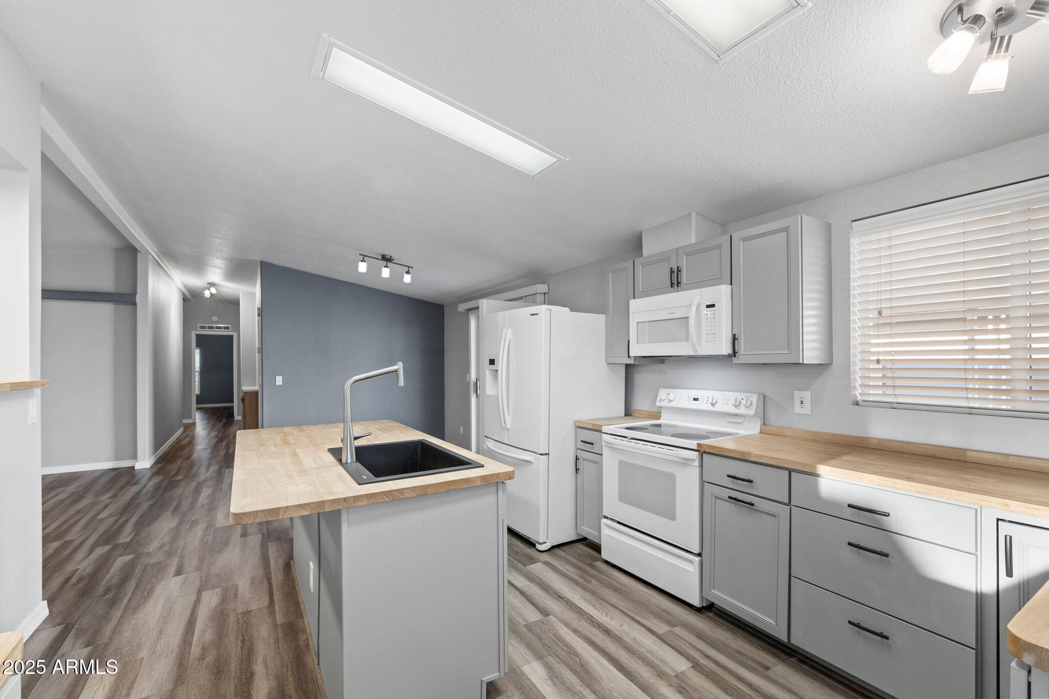 2400 East Baseline Avenue, Unit 144 Apache Junction, AZ 85119 - Photo 5 of 13 a kitchen with a sink stove and refrigerator