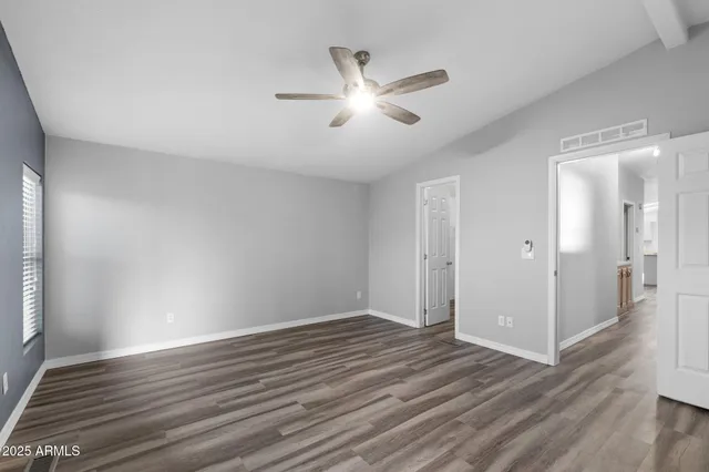 a view of empty room with wooden floor