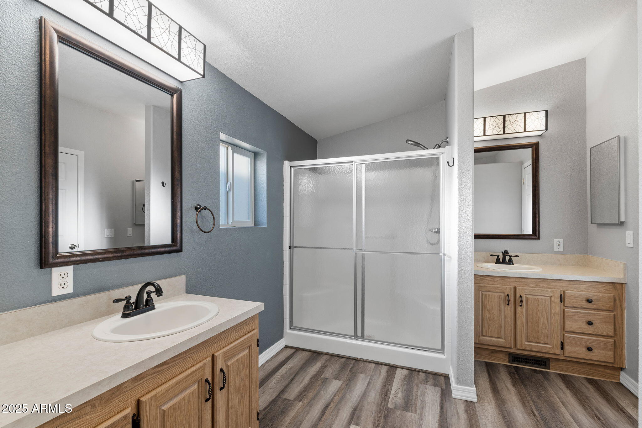 2400 East Baseline Avenue, Unit 144 Apache Junction, AZ 85119 - Photo 7 of 13 a bathroom with a sink a mirror and a shower