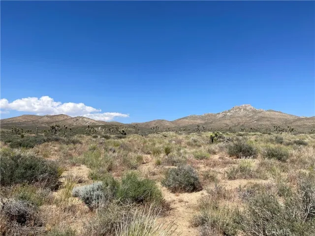 a view of a mountain range in a cloudy sky