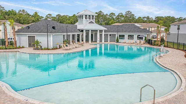 an aerial view of a house with swimming pool garden and patio