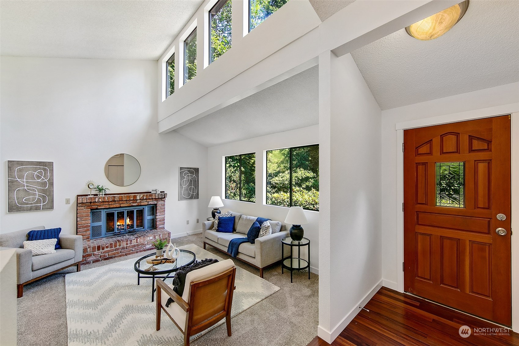 a living room with furniture fireplace and window