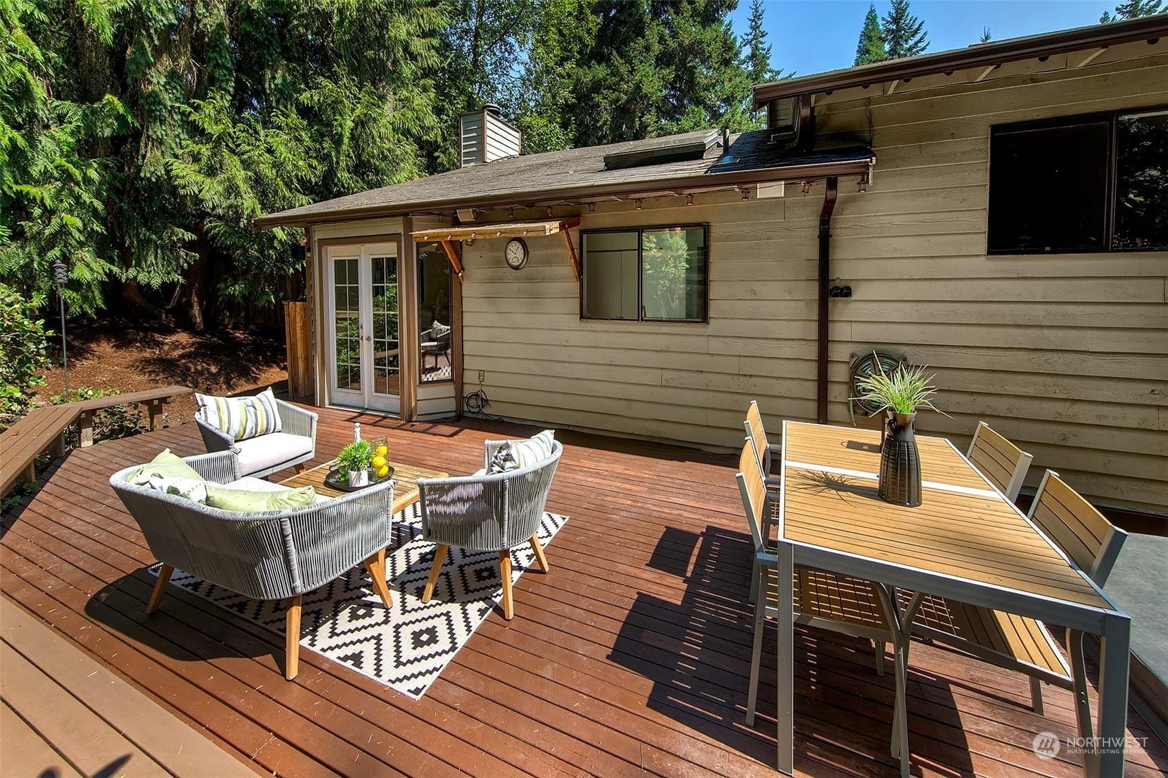 21822 4th Avenue Southeast Bothell, WA 98021 - Photo 22 of 40 a view of a patio with table and chairs with wooden floor and fence