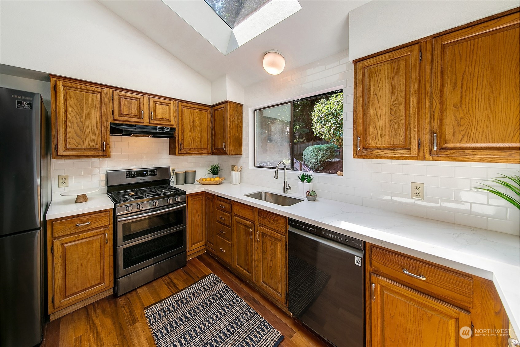 21822 4th Avenue Southeast Bothell, WA 98021 - Photo 6 of 40 a kitchen with stainless steel appliances a sink cabinets and a window